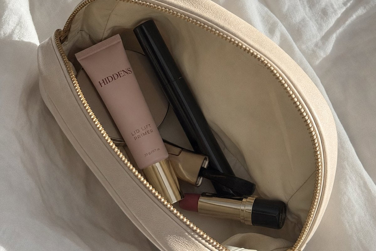 The tube and its flat brush in a makeup bag