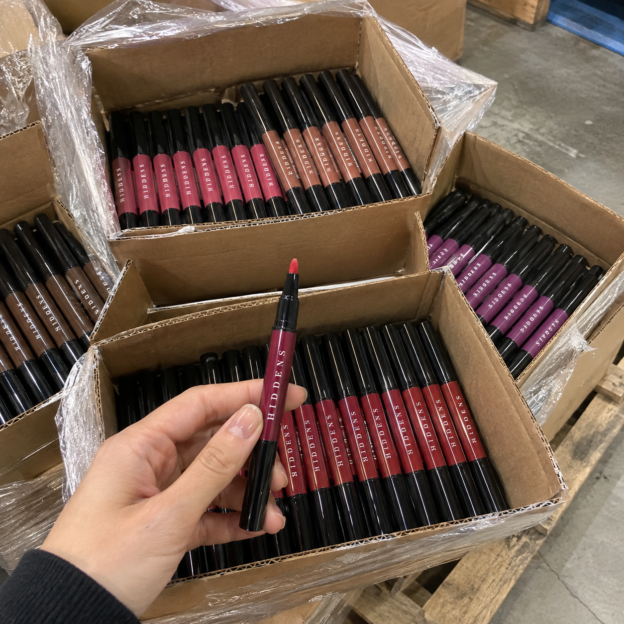 An open pallet of cartons packed with Signature Pens in many shades